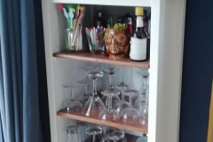 cocktail cabinet made by reducing an old chest of drawers and adding shelves and a top with wood from an old wardrode