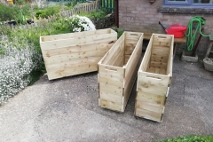 Three large planters on casters