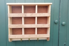 A set of nine pigeon holes made especially to store gloves and hang coats in their  stables in Harsfield